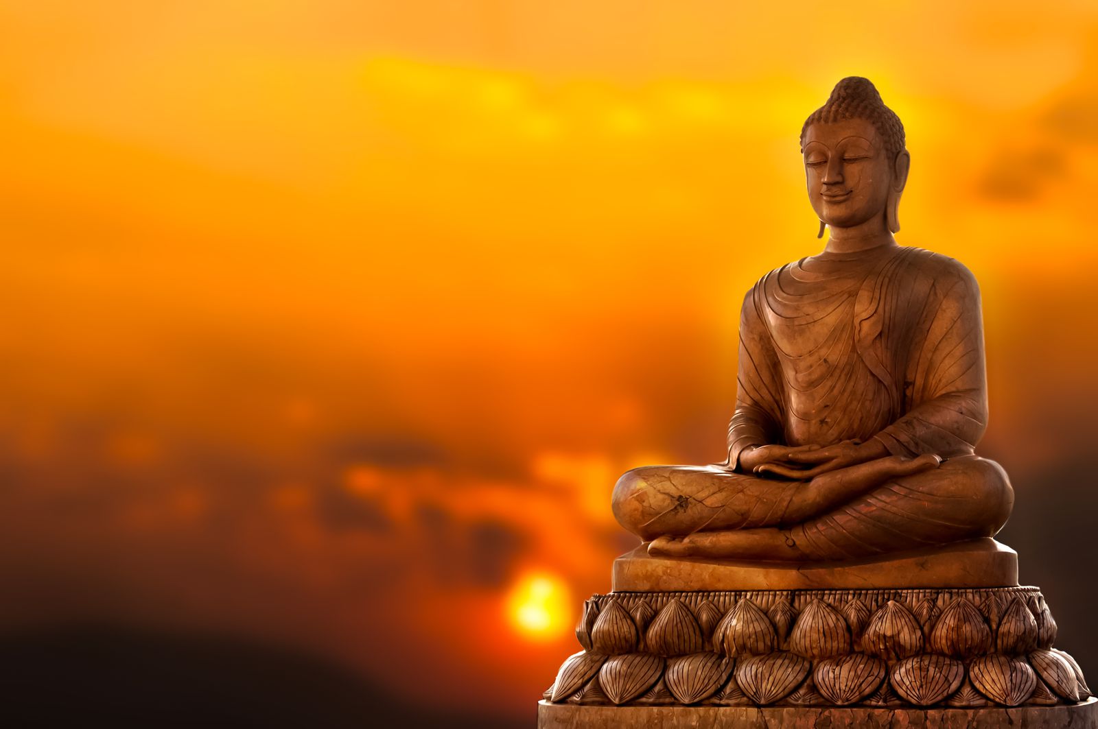 Buddha with a sunset in the background